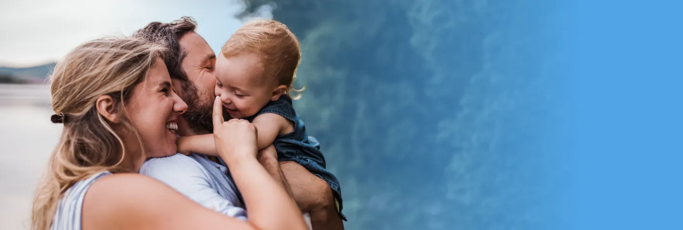 Young man and woman holding their baby